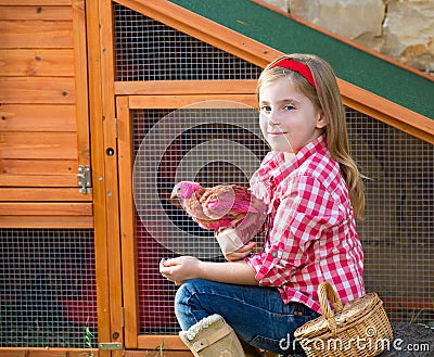 Breeder hens kid girl rancher farmer with chicks in chicken coop Stock Photo