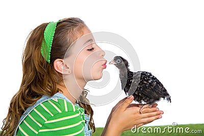 Breeder hens kid girl rancher farmer kissing a chicken chick Stock Photo