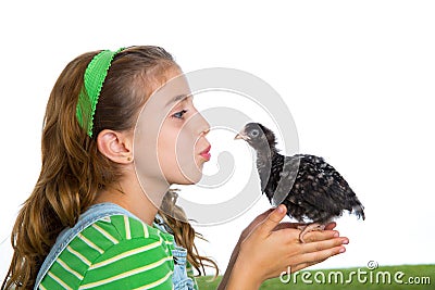 Breeder hens kid girl rancher farmer kissing a chicken chick Stock Photo