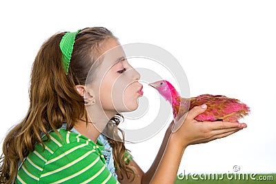 Breeder hens kid girl rancher farmer kissing a chicken chick Stock Photo