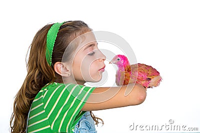 Breeder hens kid girl rancher farmer kissing a chicken chick Stock Photo