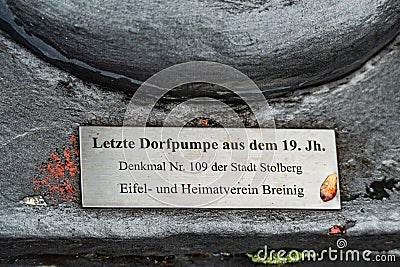 Metal plaque sign describing heritage village waterpomp Editorial Stock Photo