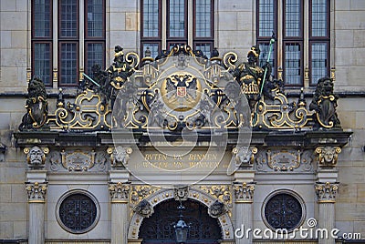 Bremen, Germany - November 7th, 2017 - Richly ornamented pediment above the main entrance to the Chamber of Commerce with golden l Editorial Stock Photo