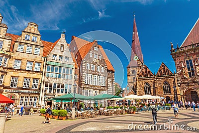 Bremen: View of the Central Square of Bremen with traditional Gothic architecture, cafe, restaurants and walking people Editorial Stock Photo