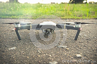 Brend new drone on the asphalt with lens flare. Stock Photo