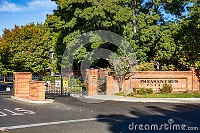 Brentwood, California October 20, 2023: Pheasant Run Estates entrance in Brentwood, California with a gate, green trees and a Editorial Stock Photo