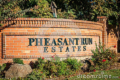 Brentwood, California October 20, 2023: Pheasant Run Estates entrance in Brentwood, California with a gate, green trees and a Editorial Stock Photo