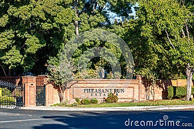 Brentwood, California October 20, 2023: Pheasant Run Estates entrance in Brentwood, California with a gate, green trees and a Editorial Stock Photo