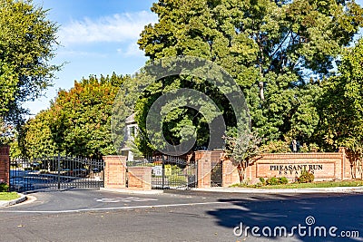 Brentwood, California October 20, 2023: Pheasant Run Estates entrance in Brentwood, California with a gate, green trees and a Editorial Stock Photo