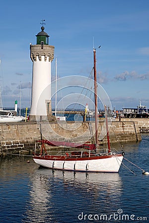 Breton port on the Atlantic coast with boats and a lighthouse Stock Photo