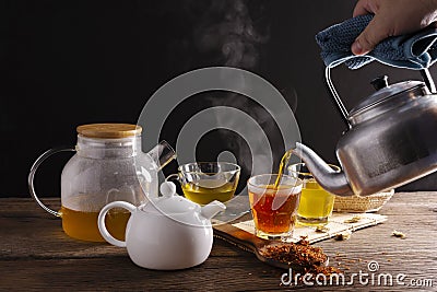 Brew hot tea, chrysanthemum tea, and chrysanthemum flowers. Safflower arranged on a wooden table Healthy drinks to drink herbs and Stock Photo