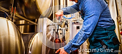 Brewer filling beer in bottle Stock Photo