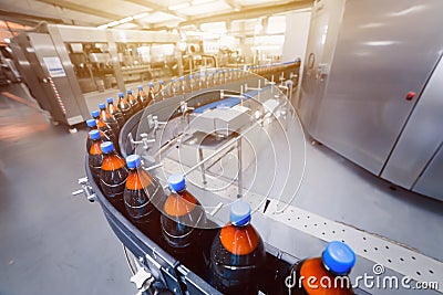 Brewery conveyor line. Automatic beer filling line. Bottles on the conveyor. Stock Photo