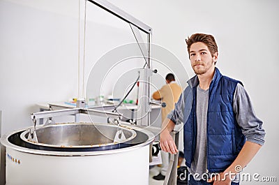 Brewery, man and meshing pot with manufacturing for wort or beer, alcohol and production process in factory. Industrial Stock Photo