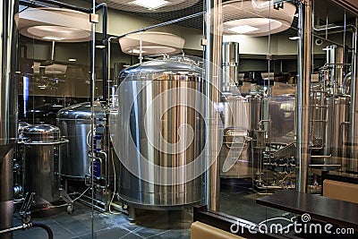 Brewery manufacturing factory. Stainless steel vats or tanks with pipes, small brewing equipment, modern alcohol production Stock Photo