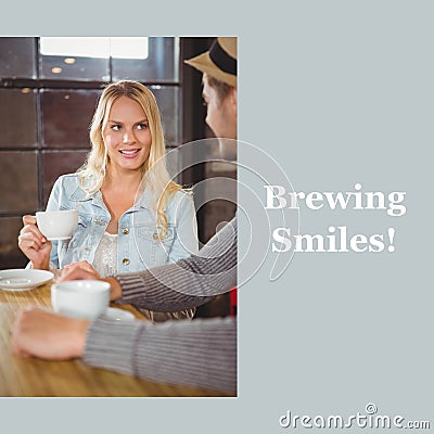 Brewing smiles text on grey with happy caucasain couple drinking coffees and talking in cafe Stock Photo