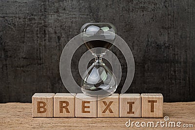 Brexit, time countdown for the UK to deal and withdraw from Euro zone concept, sandglass or hourglass on wooden cube block with Stock Photo