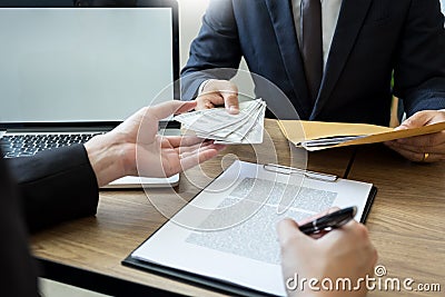 Bribe and corruption concept, Corrupted businessman sealing the deal hand receiving venality bribe money from partner Stock Photo