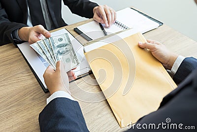 Bribe and corruption concept, Corrupted businessman sealing the deal hand receiving venality bribe money from partner Stock Photo