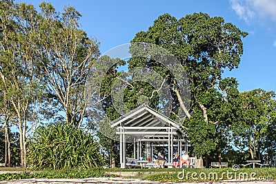 Bribie Island Queensland Australia - Tourist sit in park shelter under huge trees enjoying the day on the Sunset Coast Editorial Stock Photo
