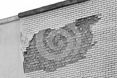 Brick grey broken masonry wall with cement white concrete damaged facade background texture old Stock Photo