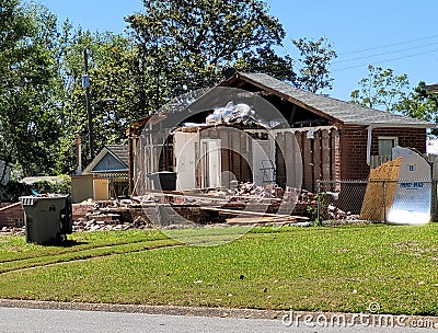 Brick house being slowly demolished Stock Photo