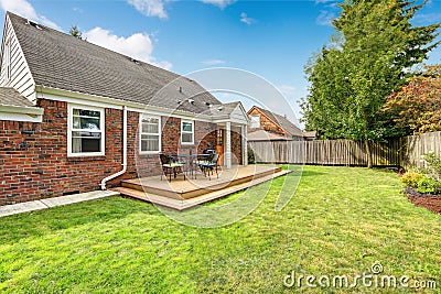 Brick house exterior with walkout wooden deck Stock Photo