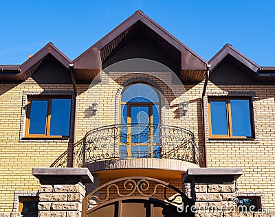 Brick house with forgery balcony, facade view Stock Photo