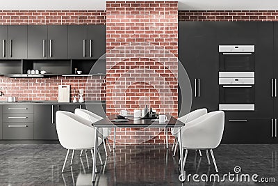 Brick kitchen with table and white armchairs Stock Photo