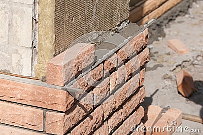 Brick laying on top of a mineral insulation Stock Photo