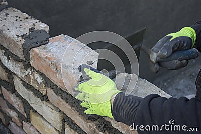 Brick mason using trowel to spread a mortar 2 Stock Photo