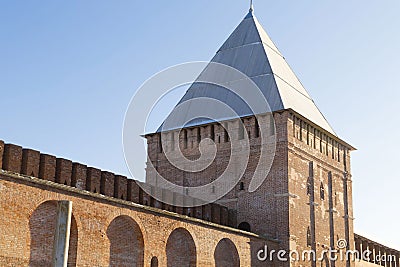 Brick old tower with a pointed roof part of the wall of the Kremlin`s protective structures, an old fort. Russia Smolensk Stock Photo