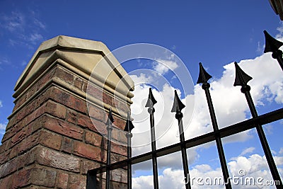 Brick & Stone Pillar with Metal Railings Stock Photo