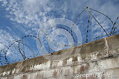 Brick wall with barbed wire Stock Photo