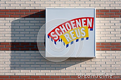 Brick wall with billboard of Dutch shop chain Schoenenreus Editorial Stock Photo