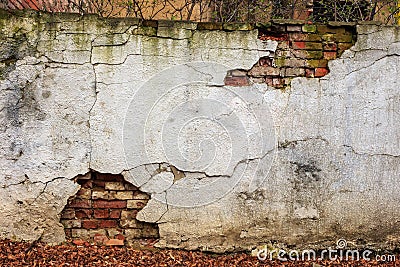 Brick wall cracked plaster Stock Photo