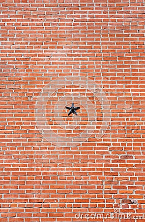 Brick Wall with Metal Star Stock Photo