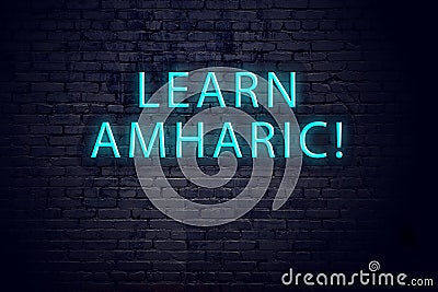 Brick wall and neon sign with inscription. Concept of learning amharic Stock Photo