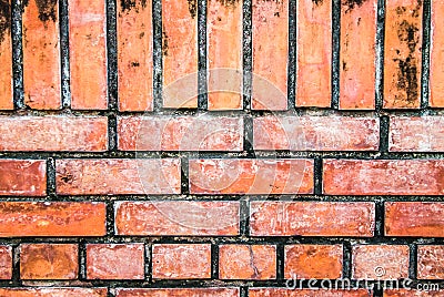 Brick wall with red bricks Red, orange brick background, arranged in complex horizontal rows in layers interlocked with cement. Stock Photo