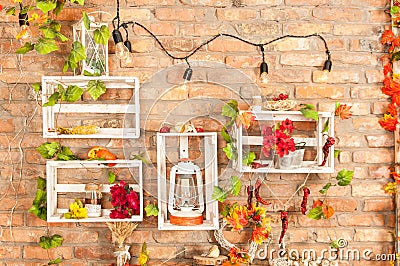 Brick wall with shelves of autumn leaves Stock Photo
