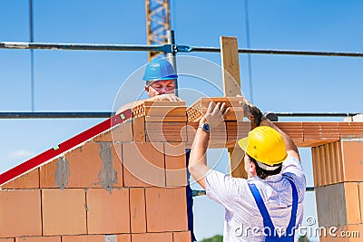 Bricklayer or builders on construction site working Stock Photo