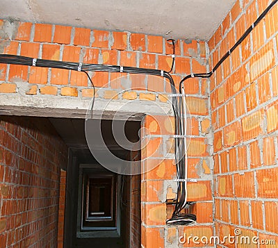 Bricklayer building new house with brick walls, interior rooms,wiring Stock Photo