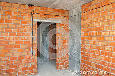 Bricklayer building new house with brick walls, interior rooms,wiring Stock Photo