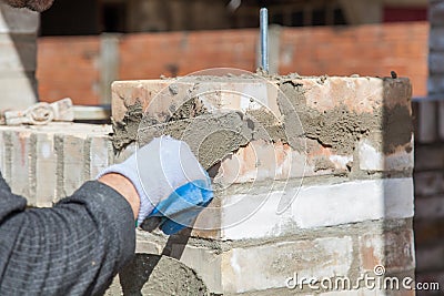 Bricklayer building wall Stock Photo