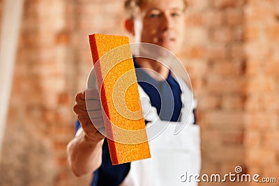 Bricklayer with tool Stock Photo