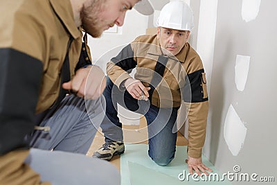 Bricklayer at work in building site Stock Photo