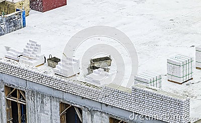 Bricklayer work on a building site - place of work of bricklaying worker on a construction site of a big residential house. White Stock Photo