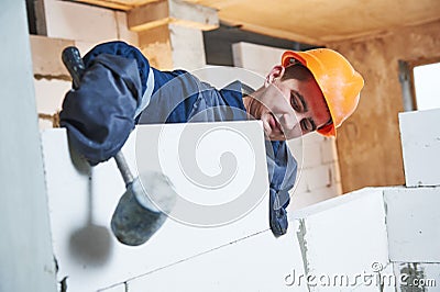 Bricklayer at work with silicate brick Stock Photo