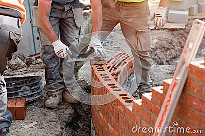 Bricklayer working on a curved wall Stock Photo
