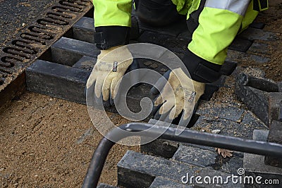 Bricklayer working on footpath at Kastruplundgade in capital Editorial Stock Photo